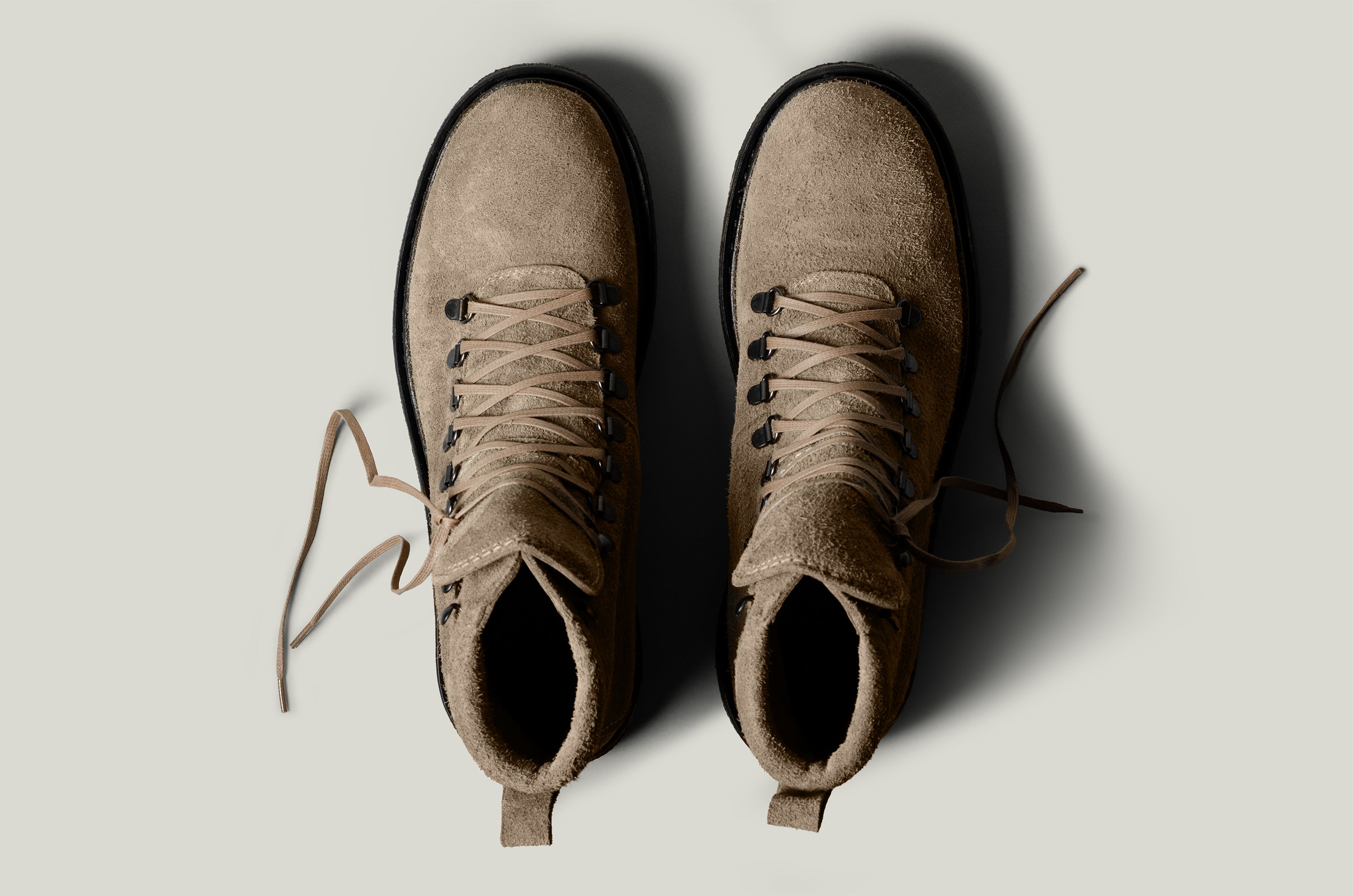 Pair of brown leather boots on a light gray background