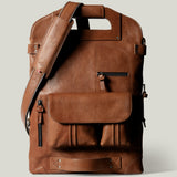 Brown leather backpack on a light gray background