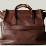 Brown leather bag on a light gray background