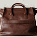 Brown leather bag on a light gray background