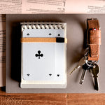 Brown leather key belt on busy background.