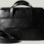 Black leather briefcase on a light gray background