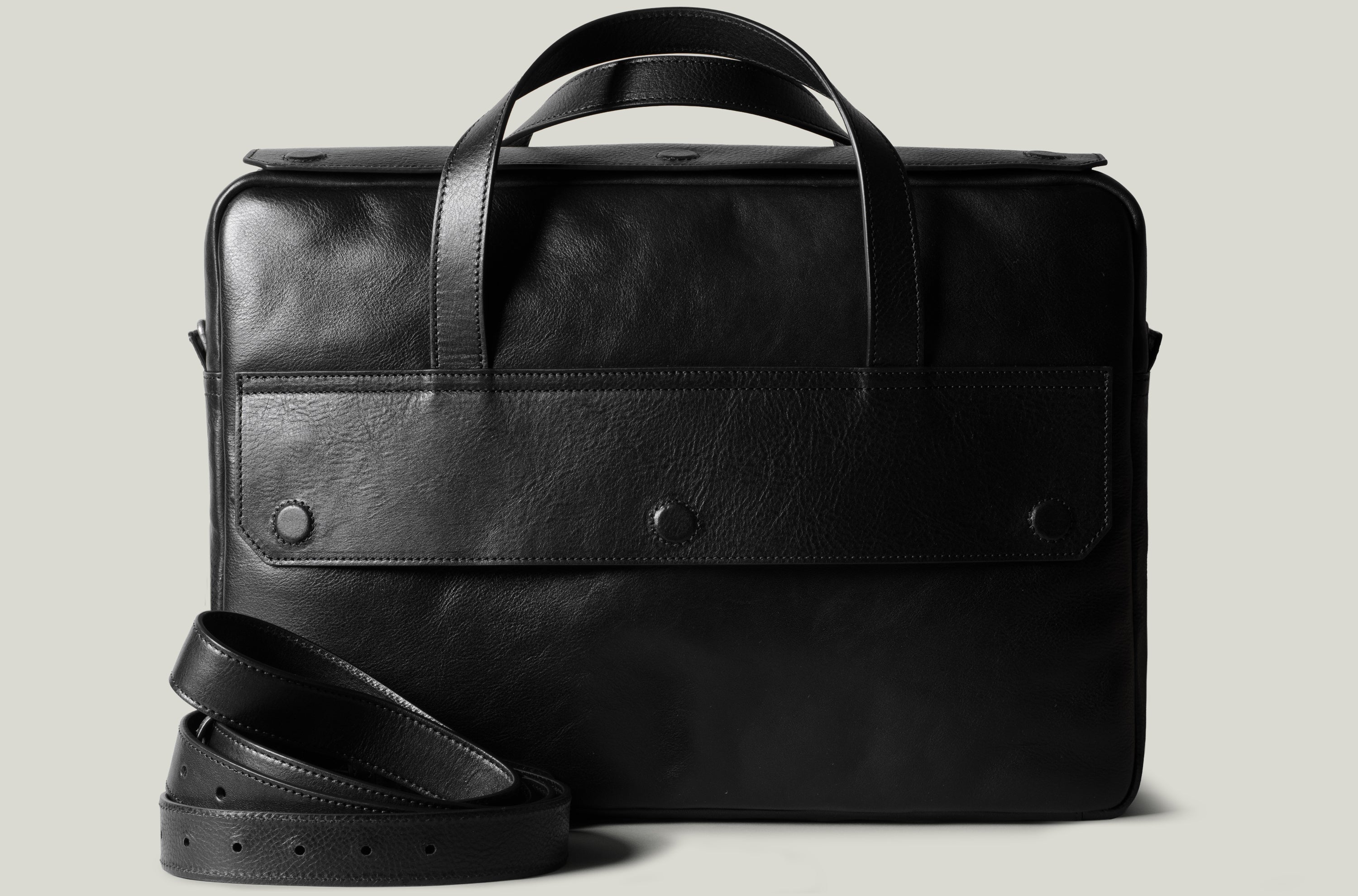 Black leather briefcase on a light gray background