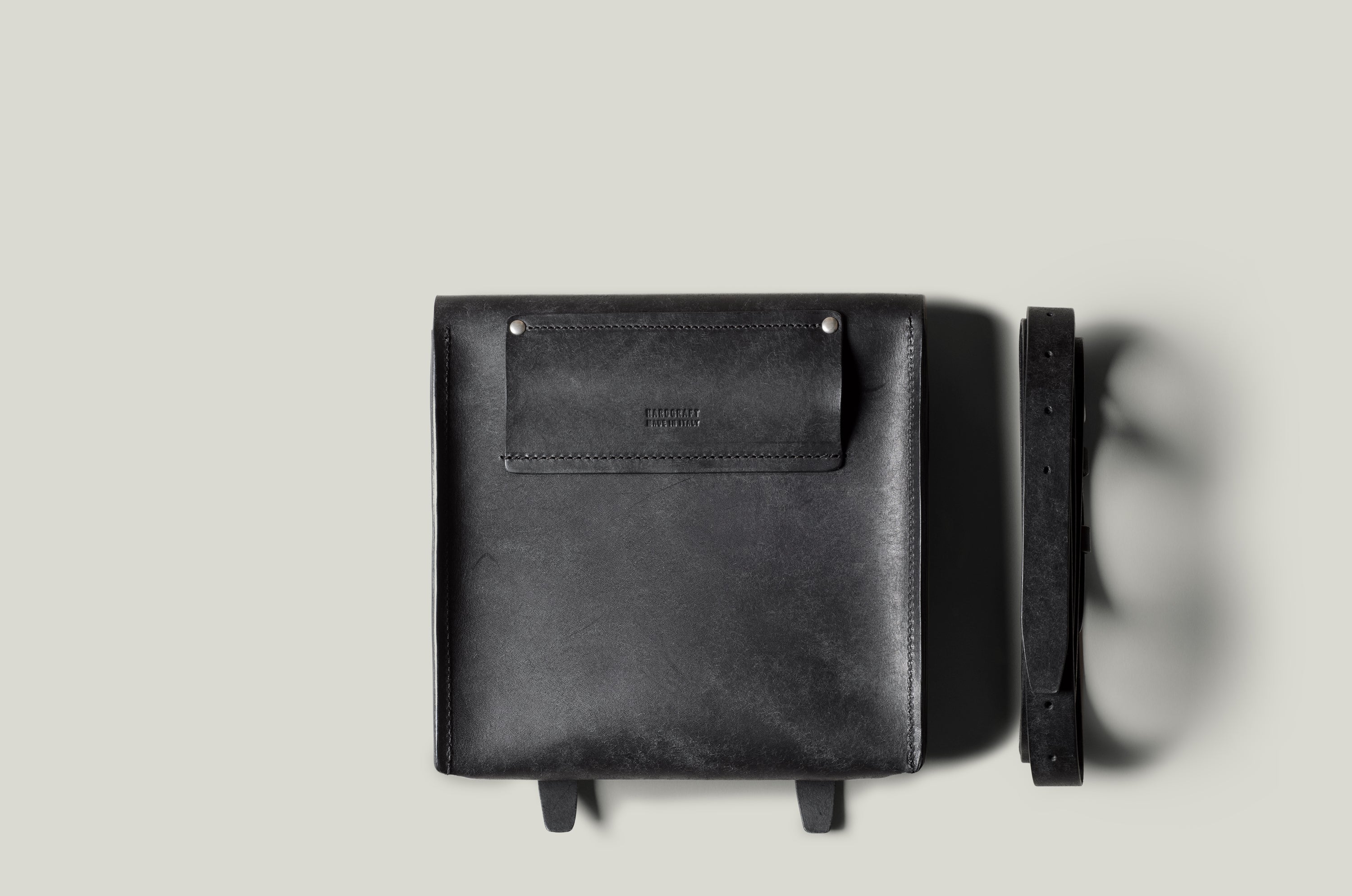 Black leather bag on a light gray background