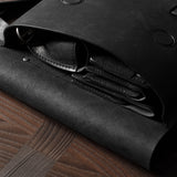 Black leather bag on a wooden surface