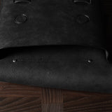 Open flap of black bag on a wooden surface