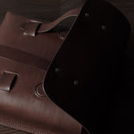 Brown leather bag on a wooden surface