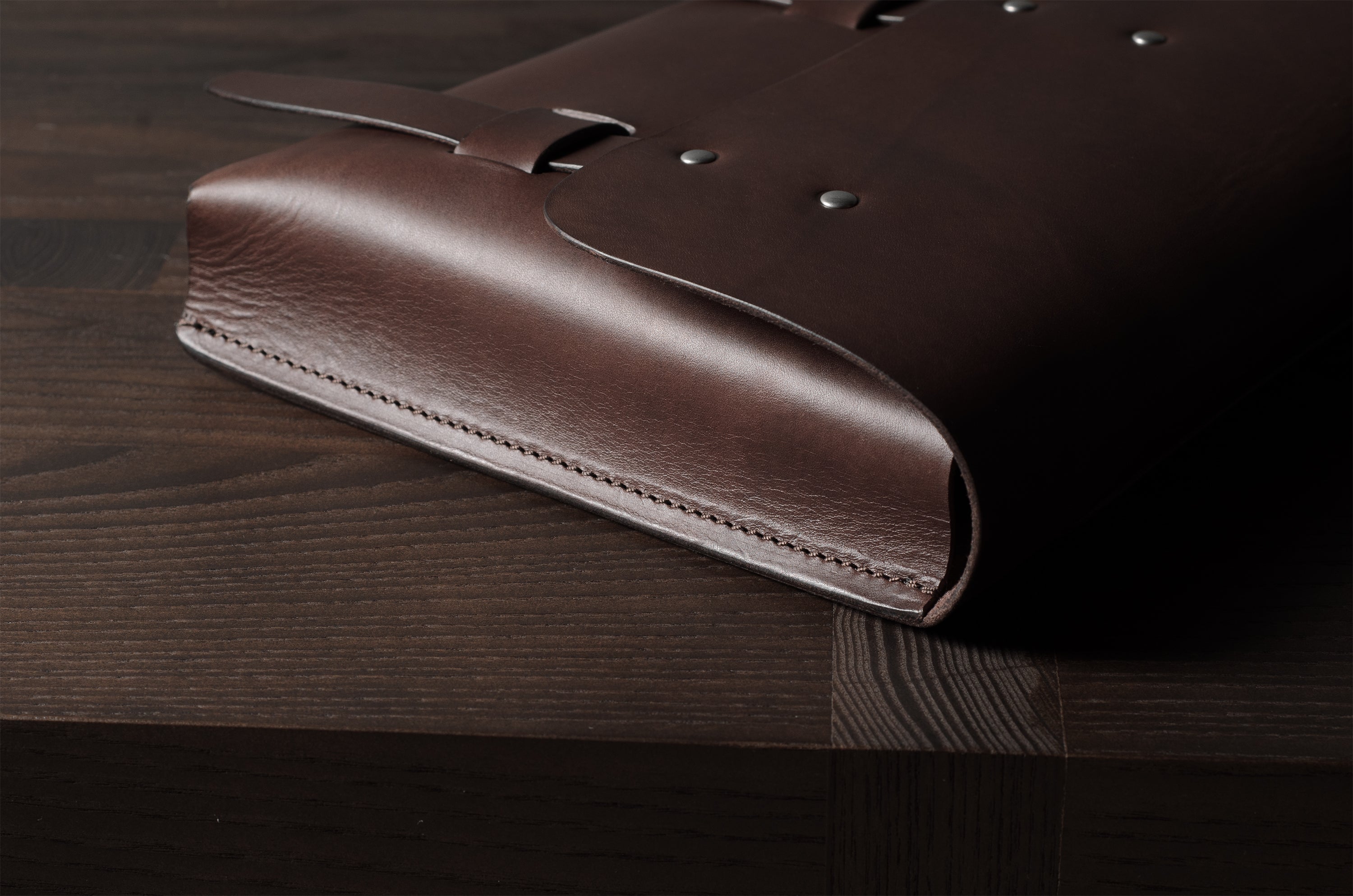 Brown leather bag on a wooden surface