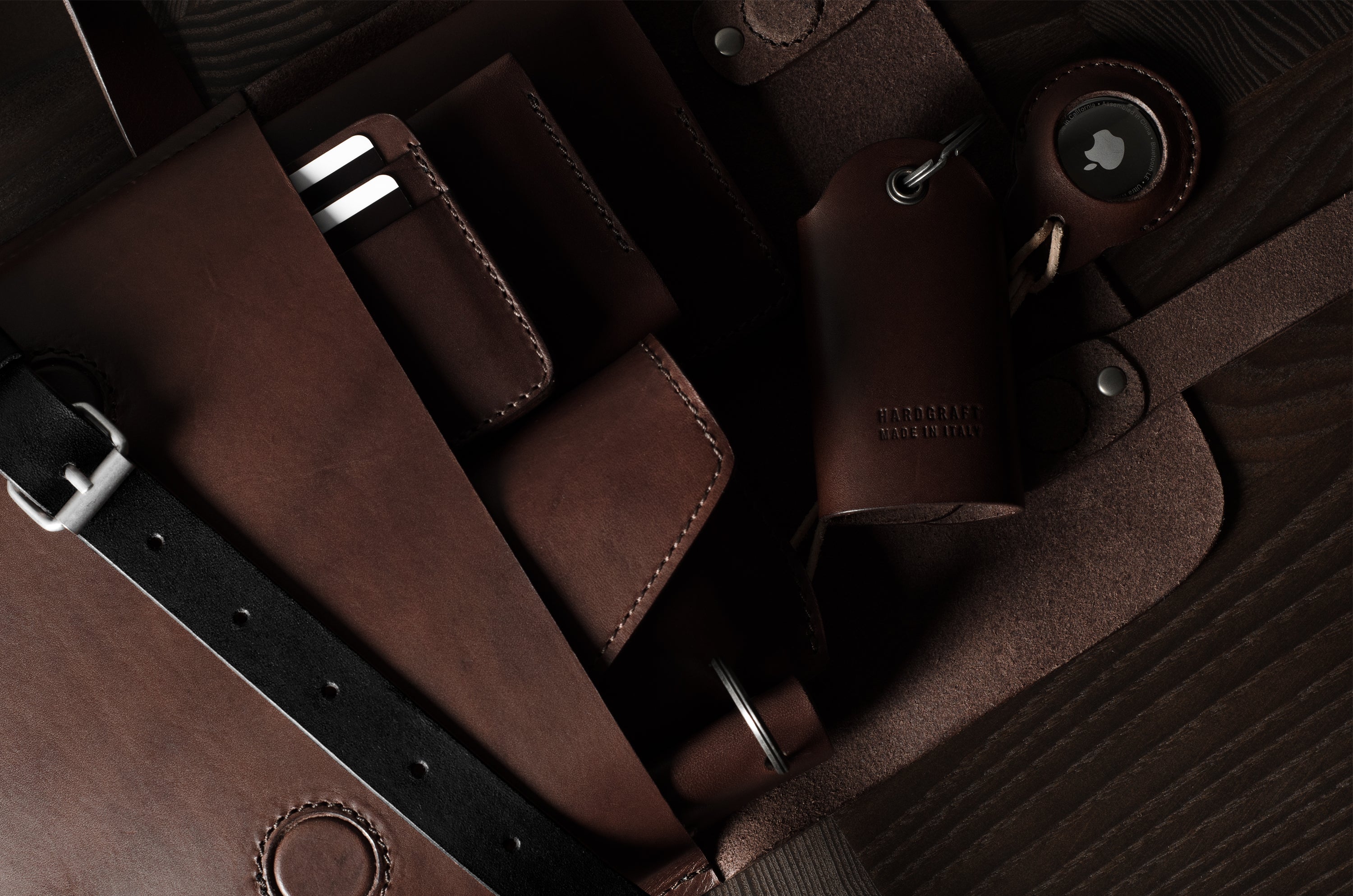 Close-up of a brown leather bag with straps on a wooden surface