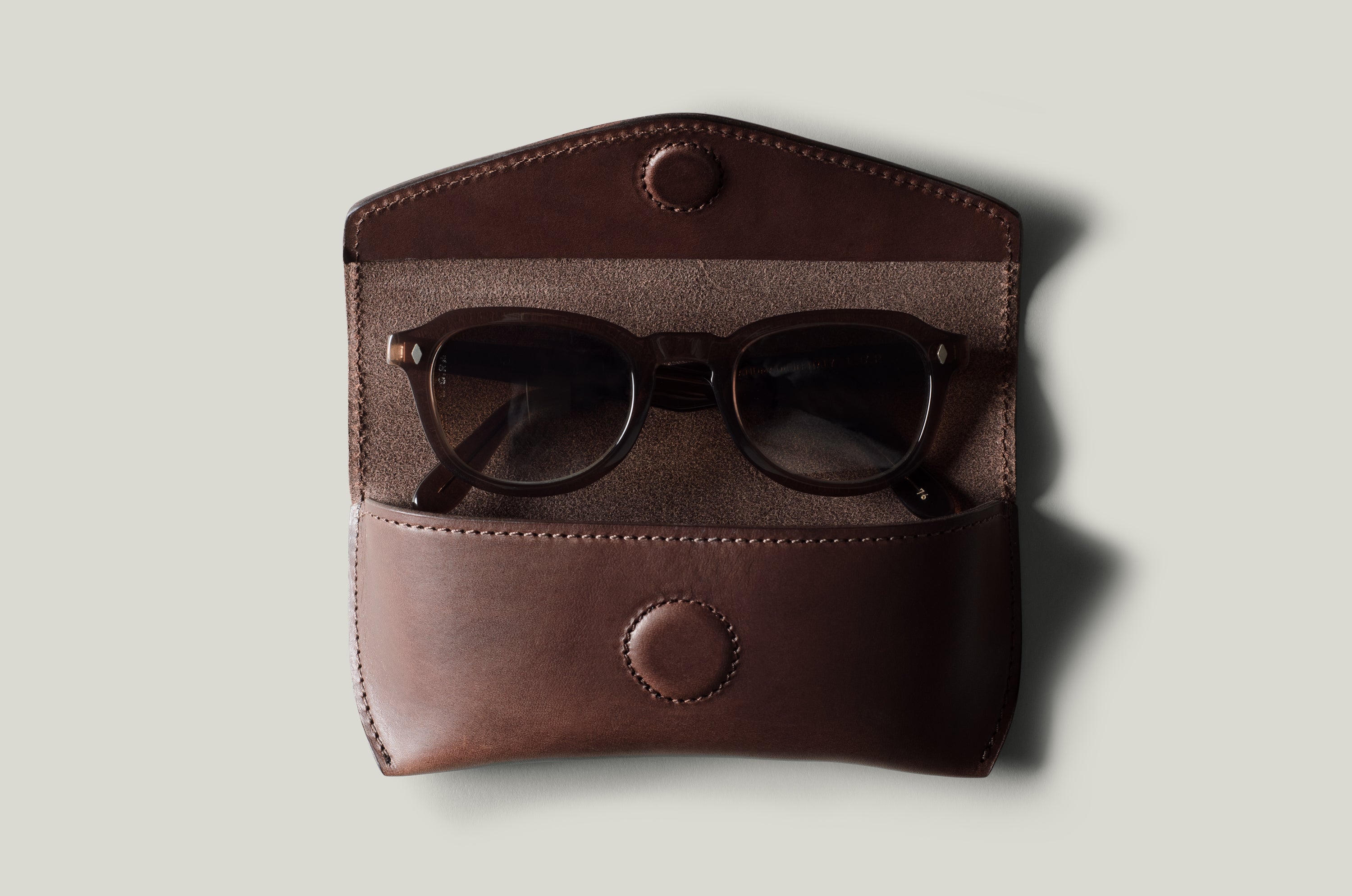 Dark brown leather glasses case with sunglasses