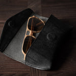 Black leather glasses case with sunglasses