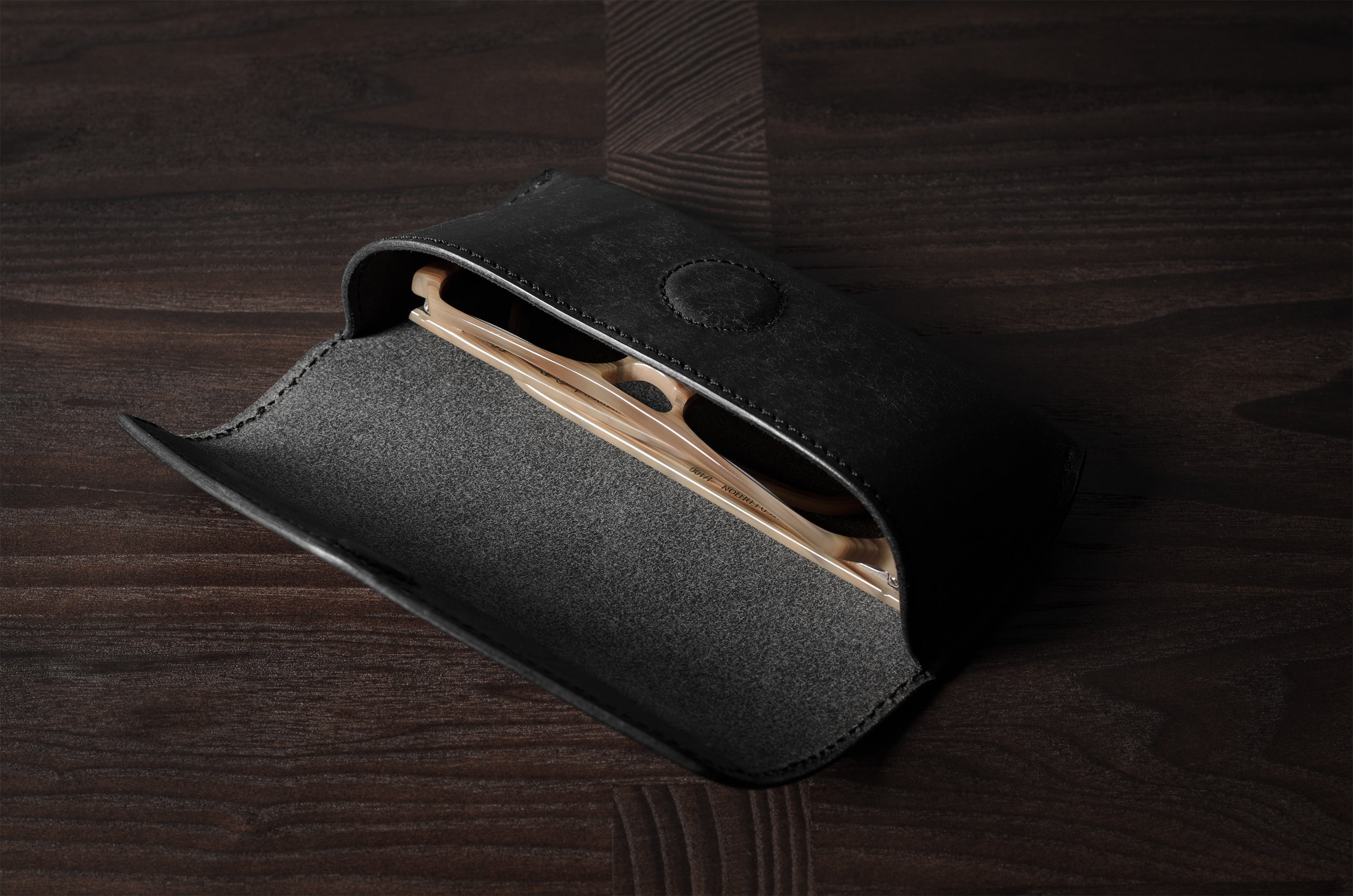 Black leather glasses case with sunglasses