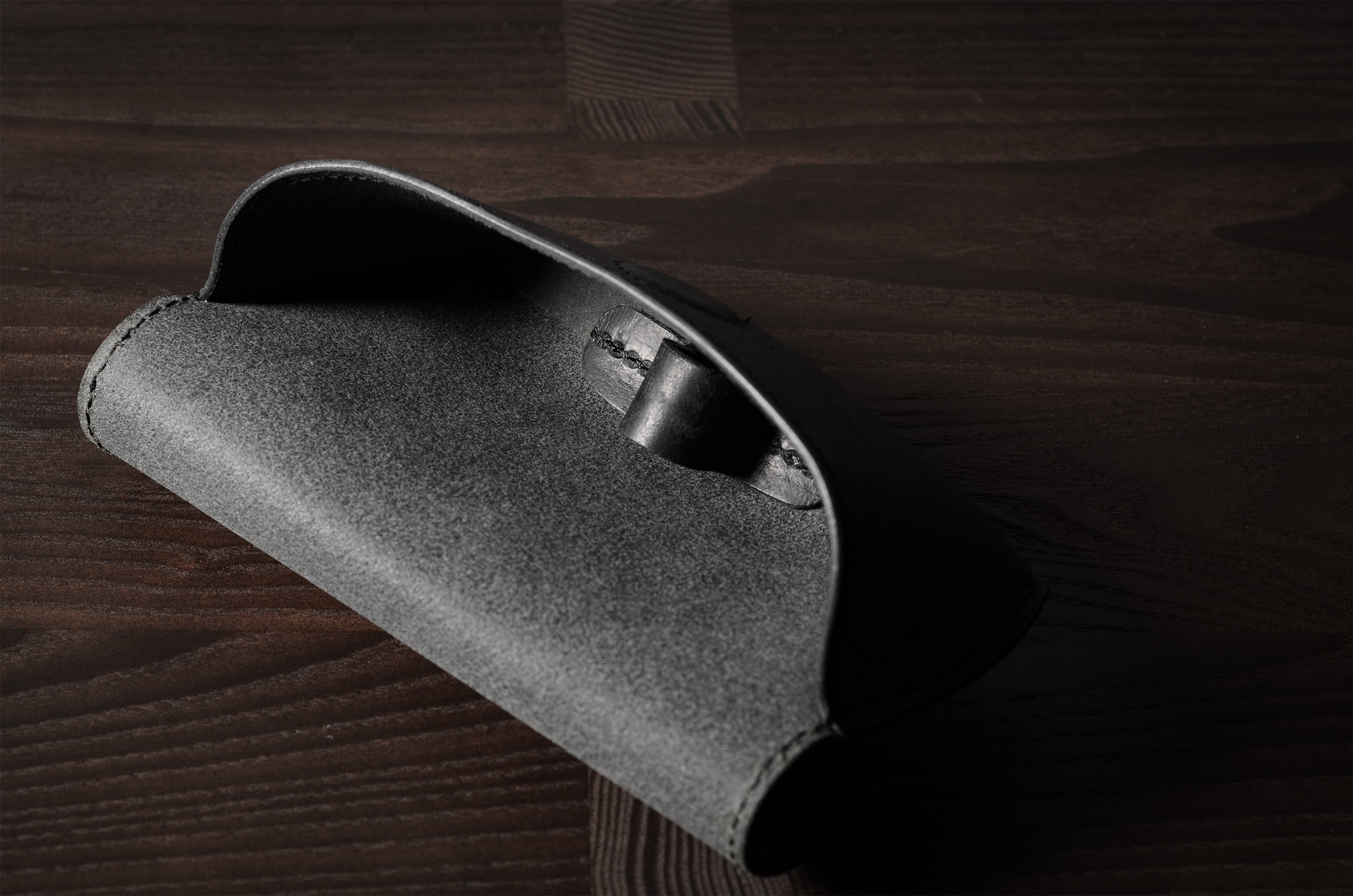 Black leather glasses case showing inside