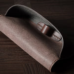 Dark brown leather glasses case showing inside