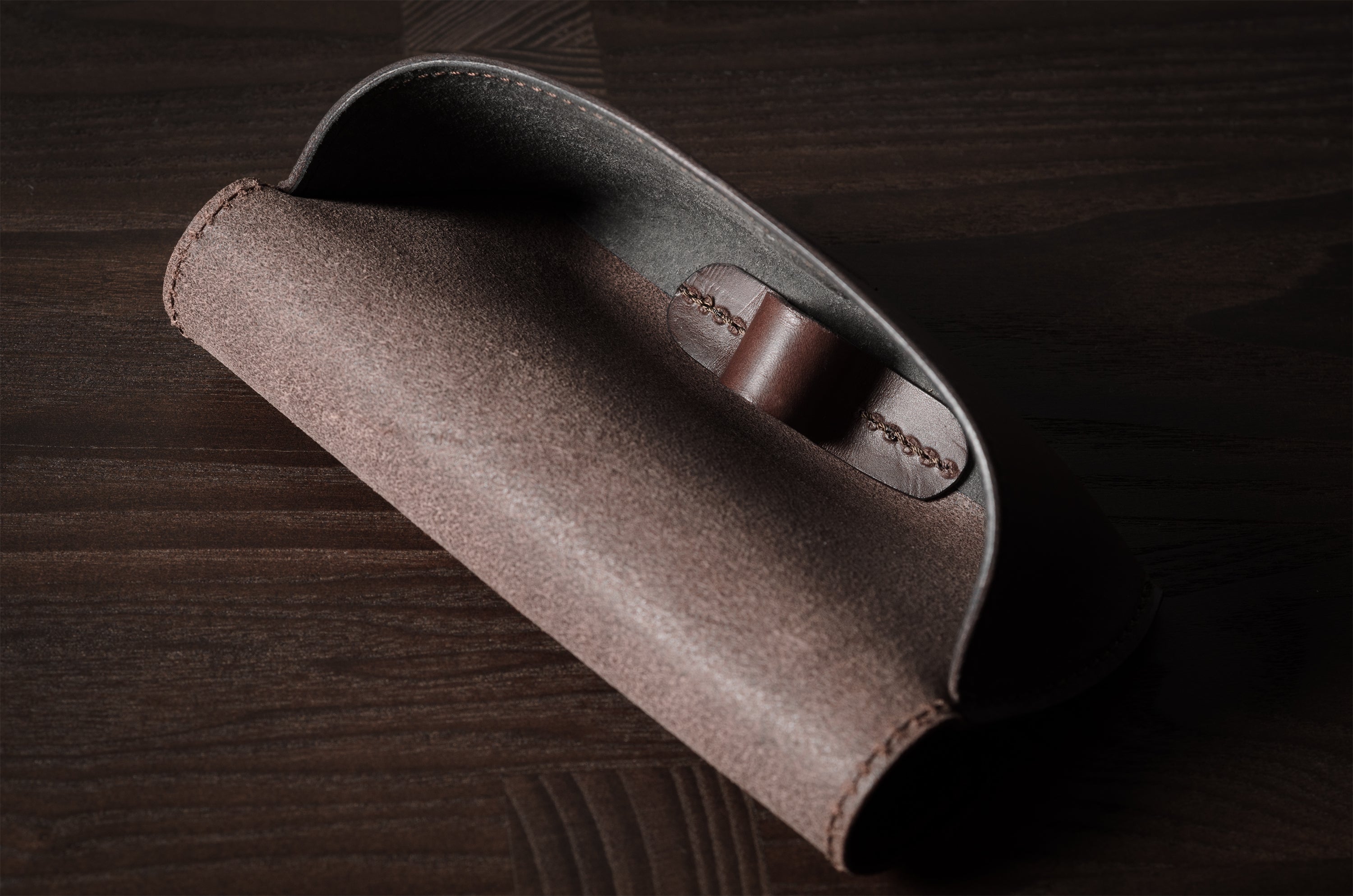 Dark brown leather glasses case showing inside