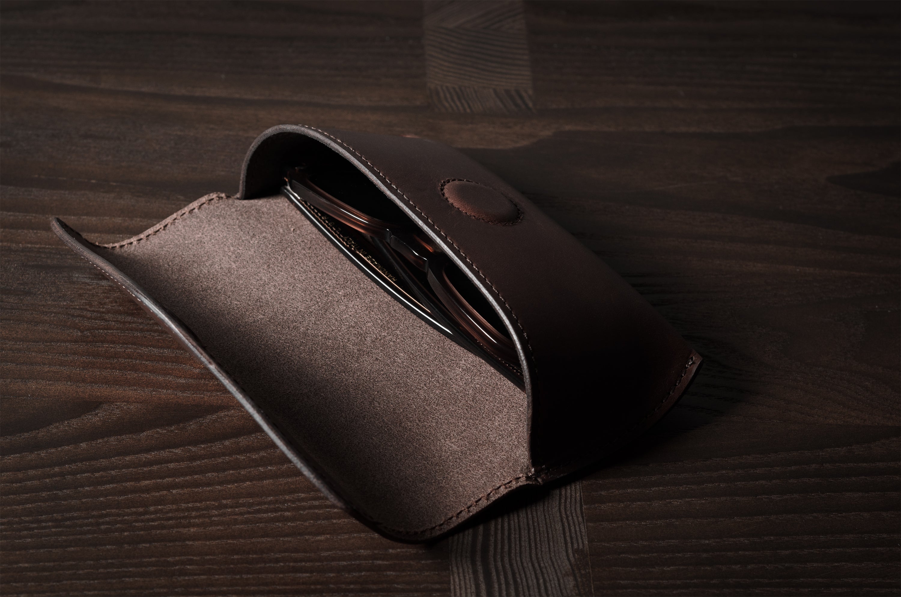 Dark brown leather glasses case with glasses