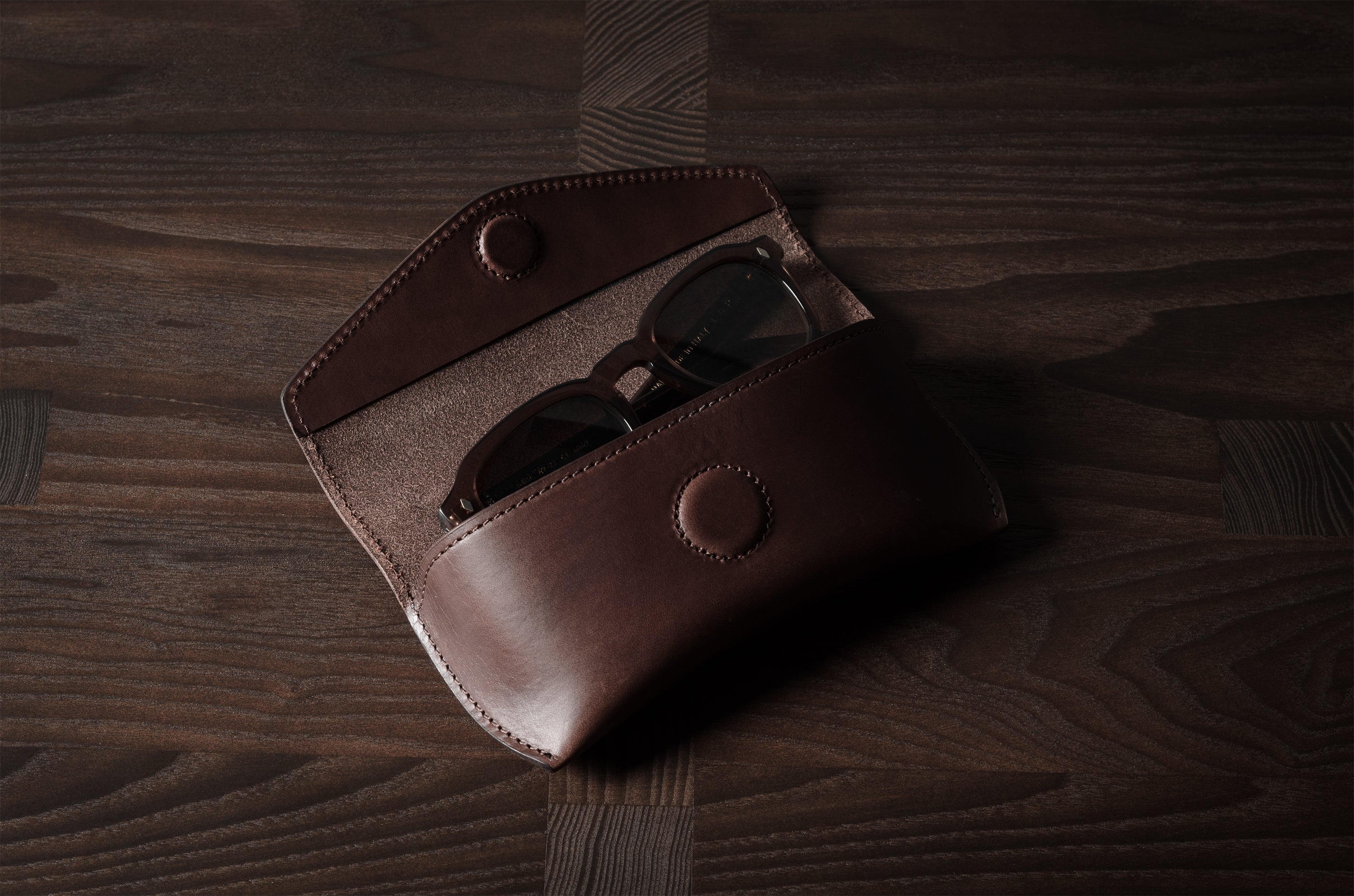 Dark brown leather glasses case with sunglasses