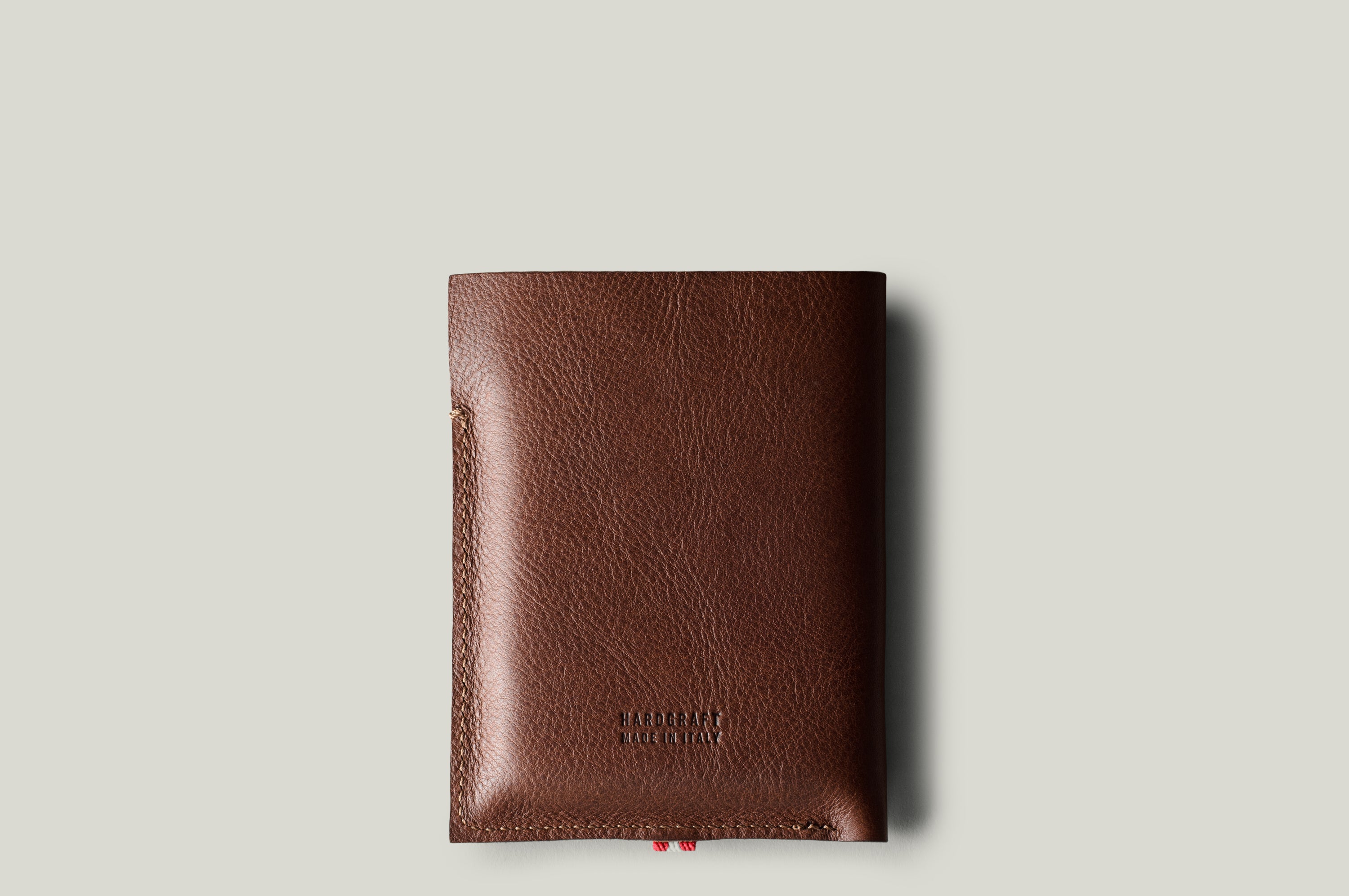 A brown leather iPhone Duo with a pebbled texture, shown vertically against a light gray background.