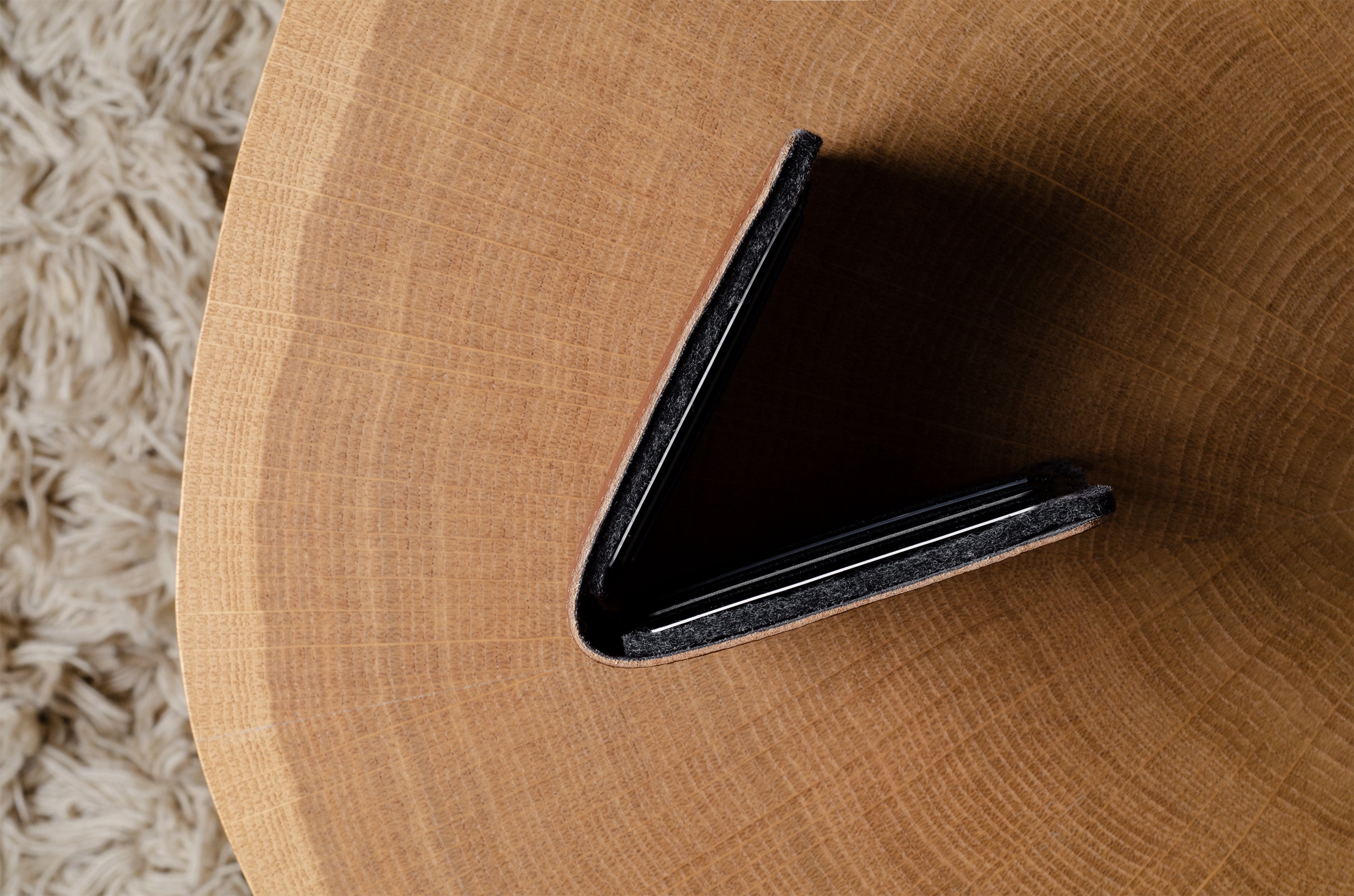 bi-fold wallet on a wooden surface