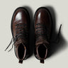 Brown leather hike boots on light grey background.