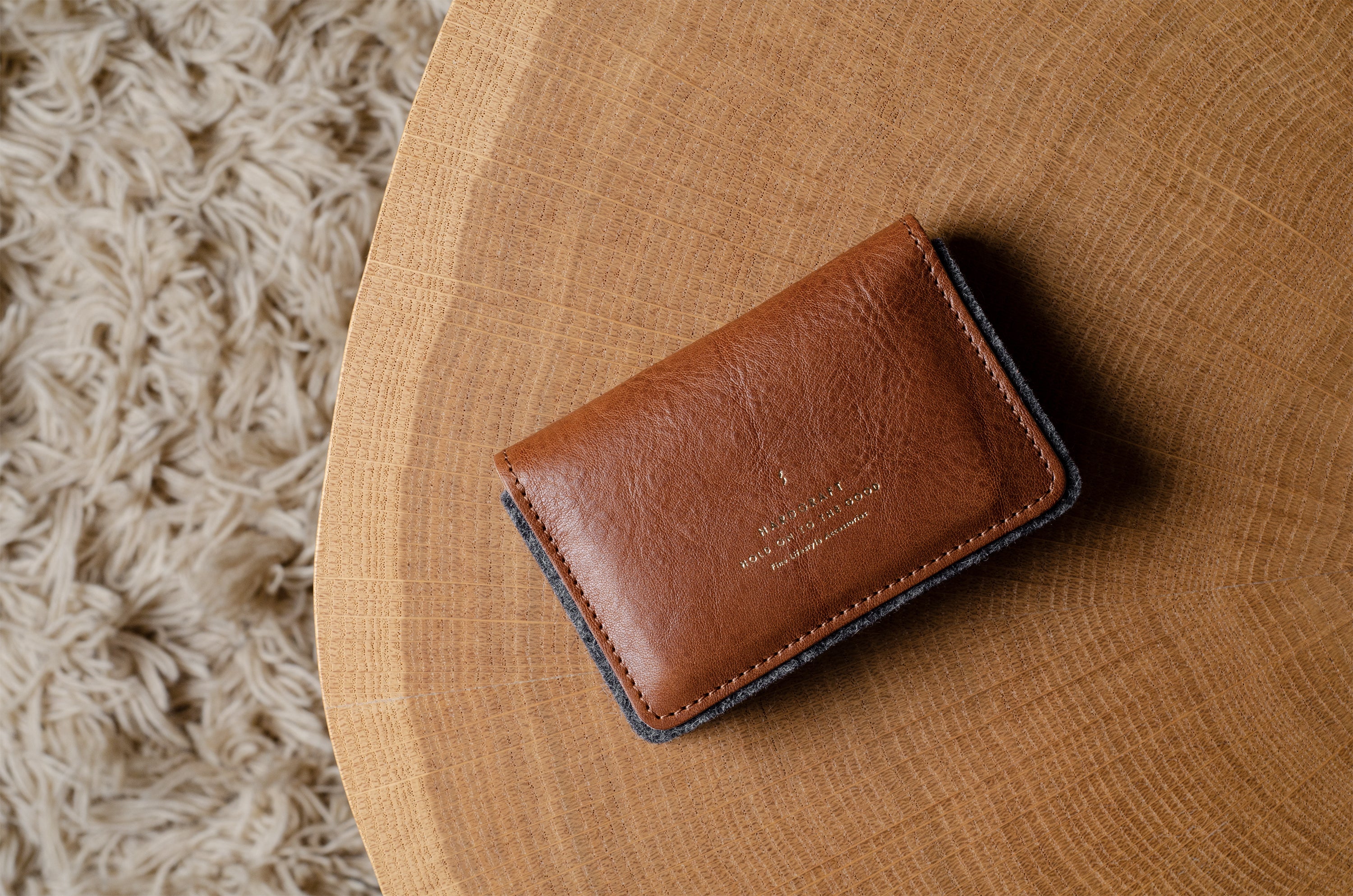 Brown leather wallet on a wooden surface