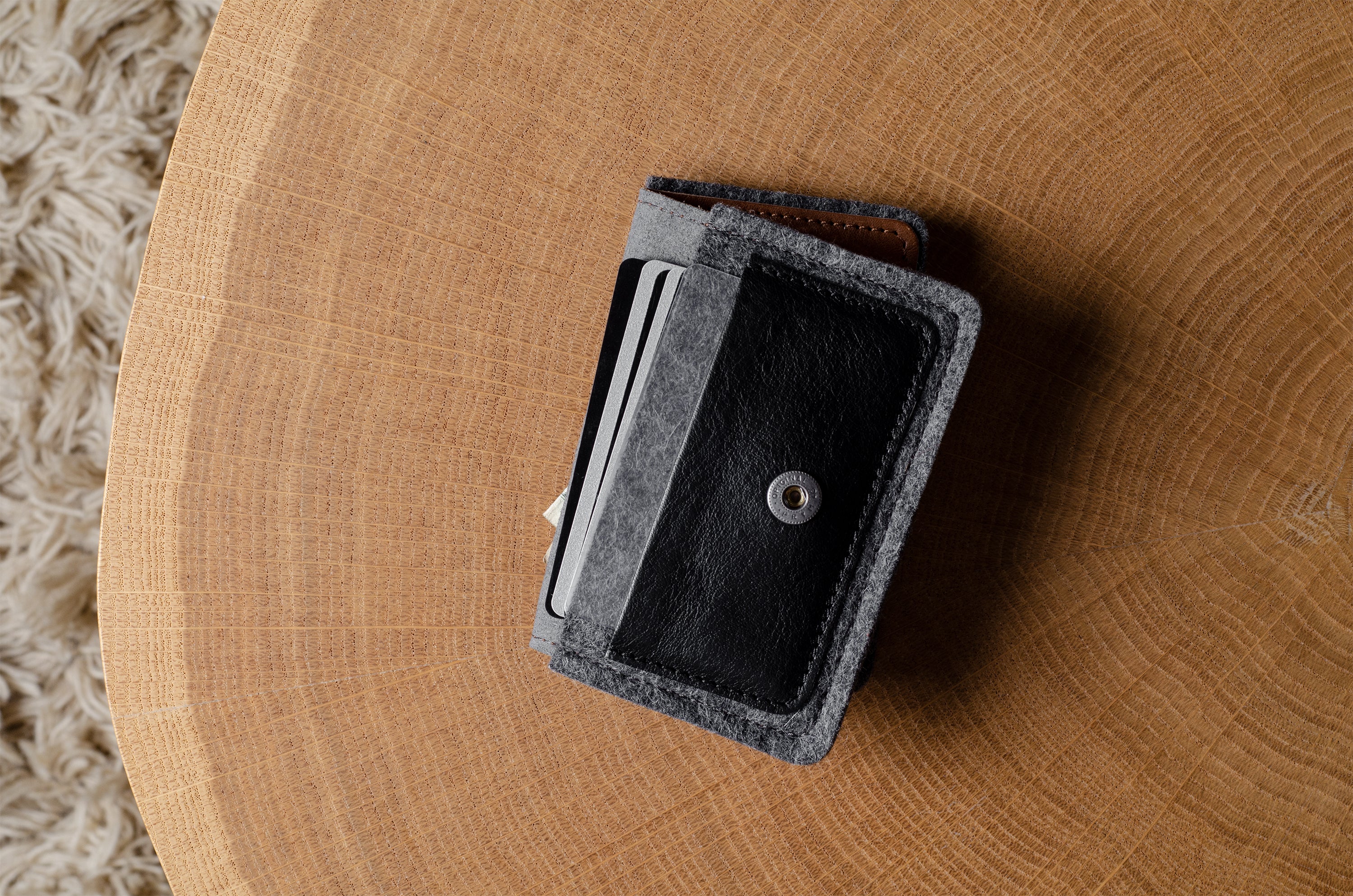 Felt wallet with card holder on a wooden surface