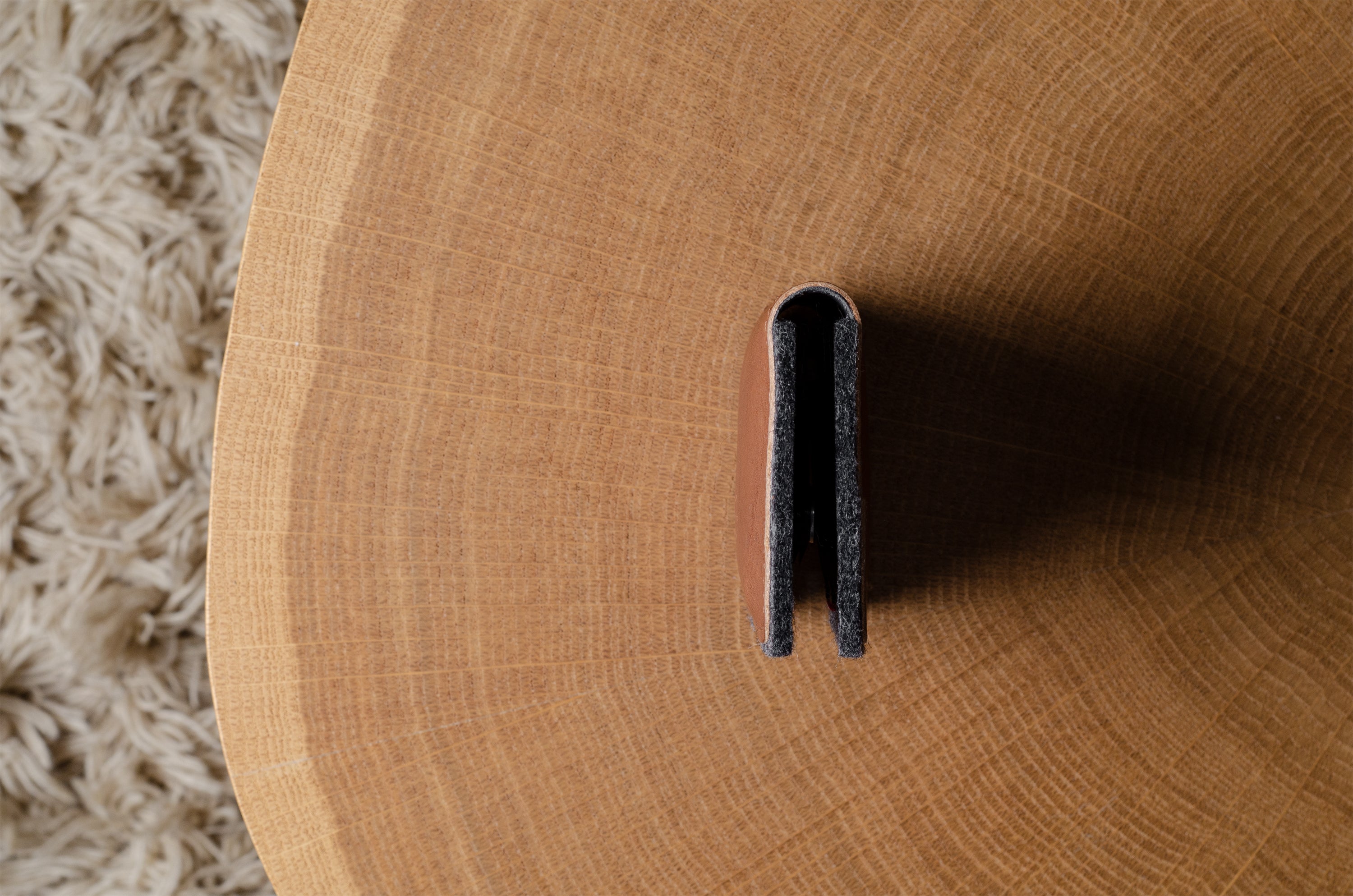 Close-up of a wooden surface with a wallet on it