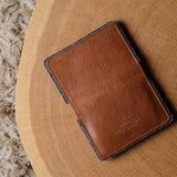 Brown leather wallet on a wooden surface