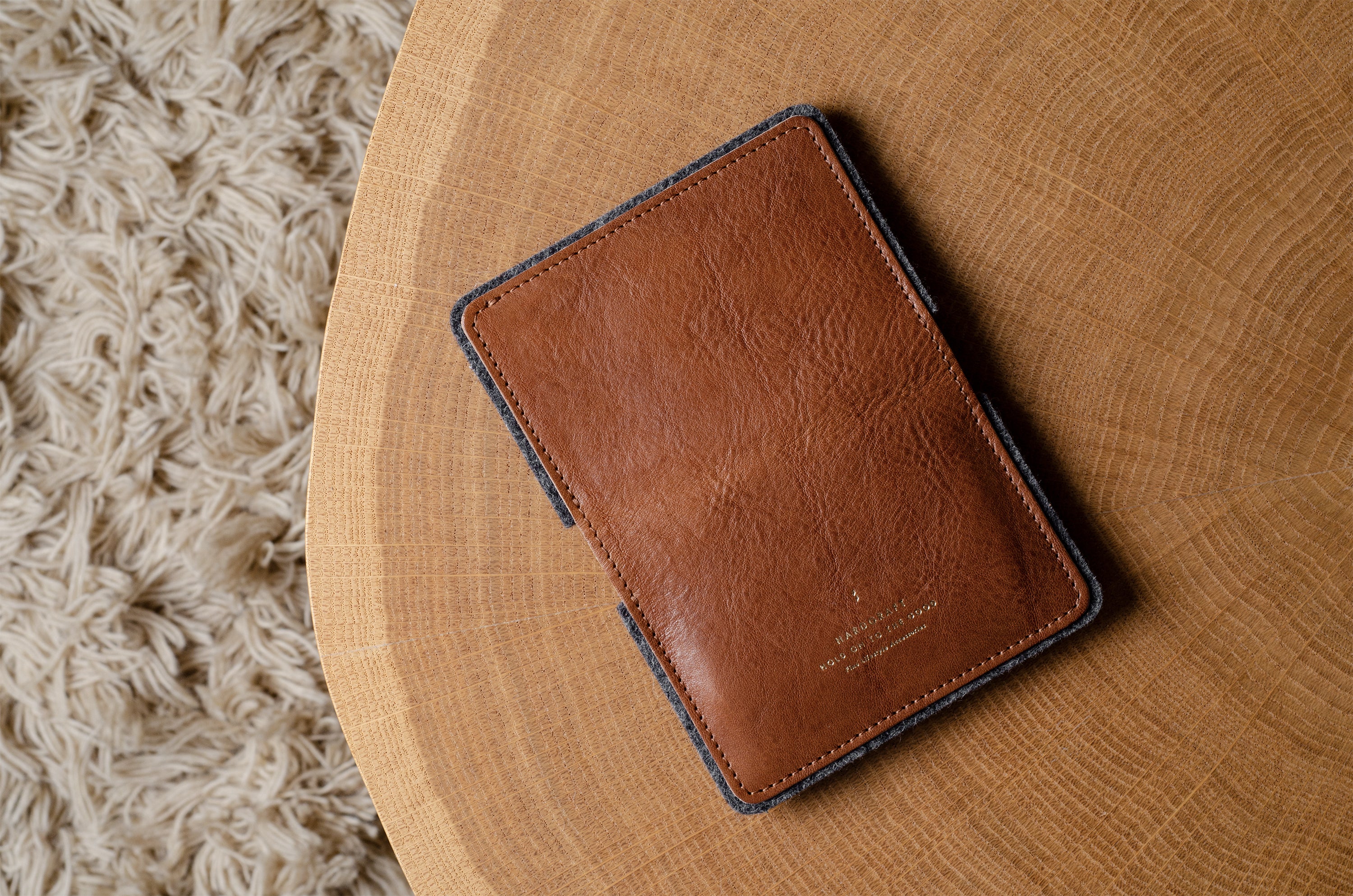 Brown leather wallet on a wooden surface