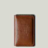 Brown leather wallet on a light gray background