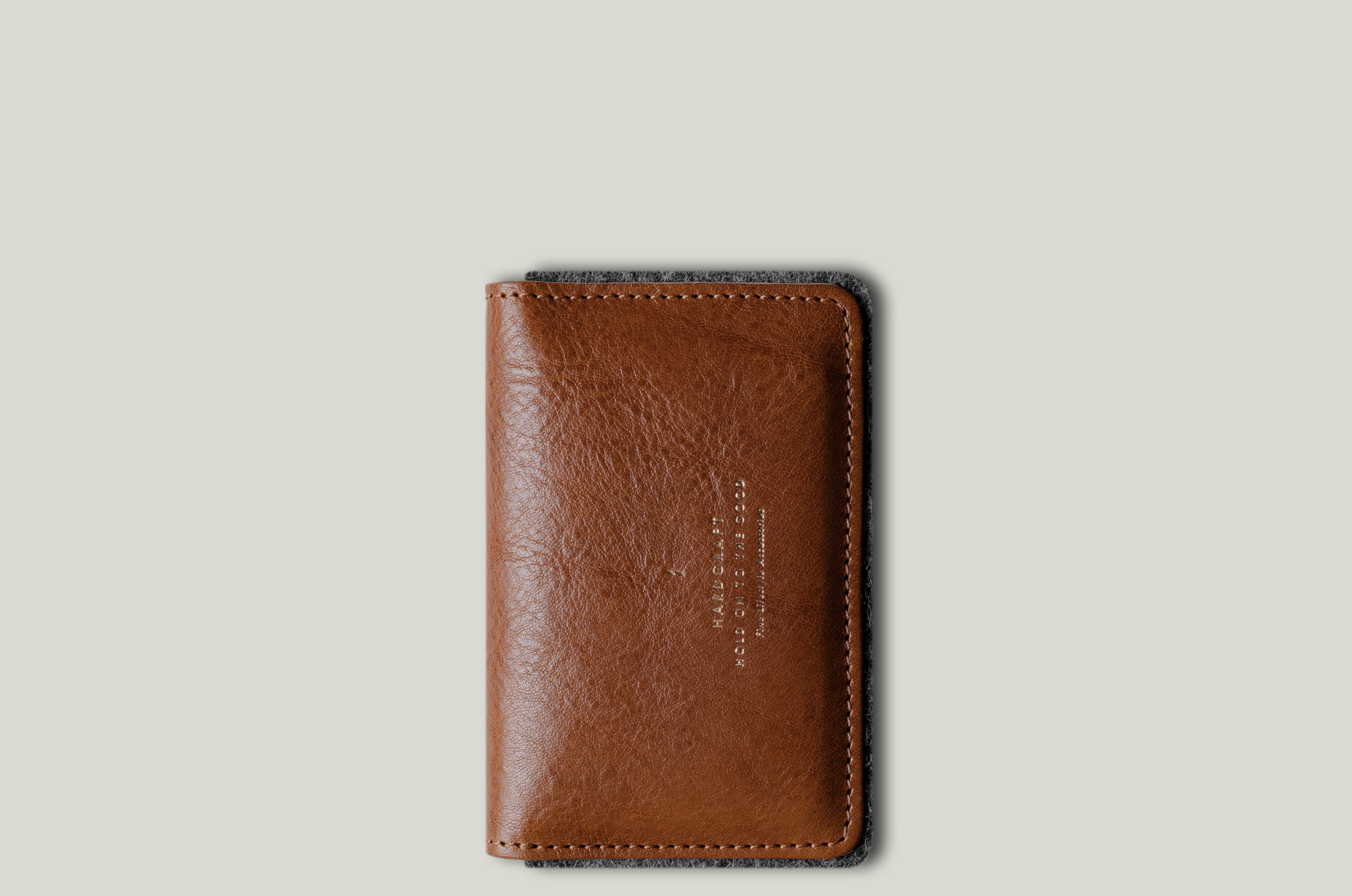 Brown leather wallet on a light gray background