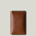 Brown leather wallet on a light gray background