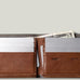 Brown leather wallet with card slots and money pocket on a light gray background
