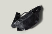 Black leather waist cross body bag with black leather details.