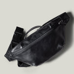 Black leather waist cross body bag with black leather details.