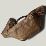 Brown waist cross body bag with technical fabric and brown leather details.