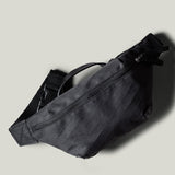 Black waist cross body bag with technical fabric and black leather details.