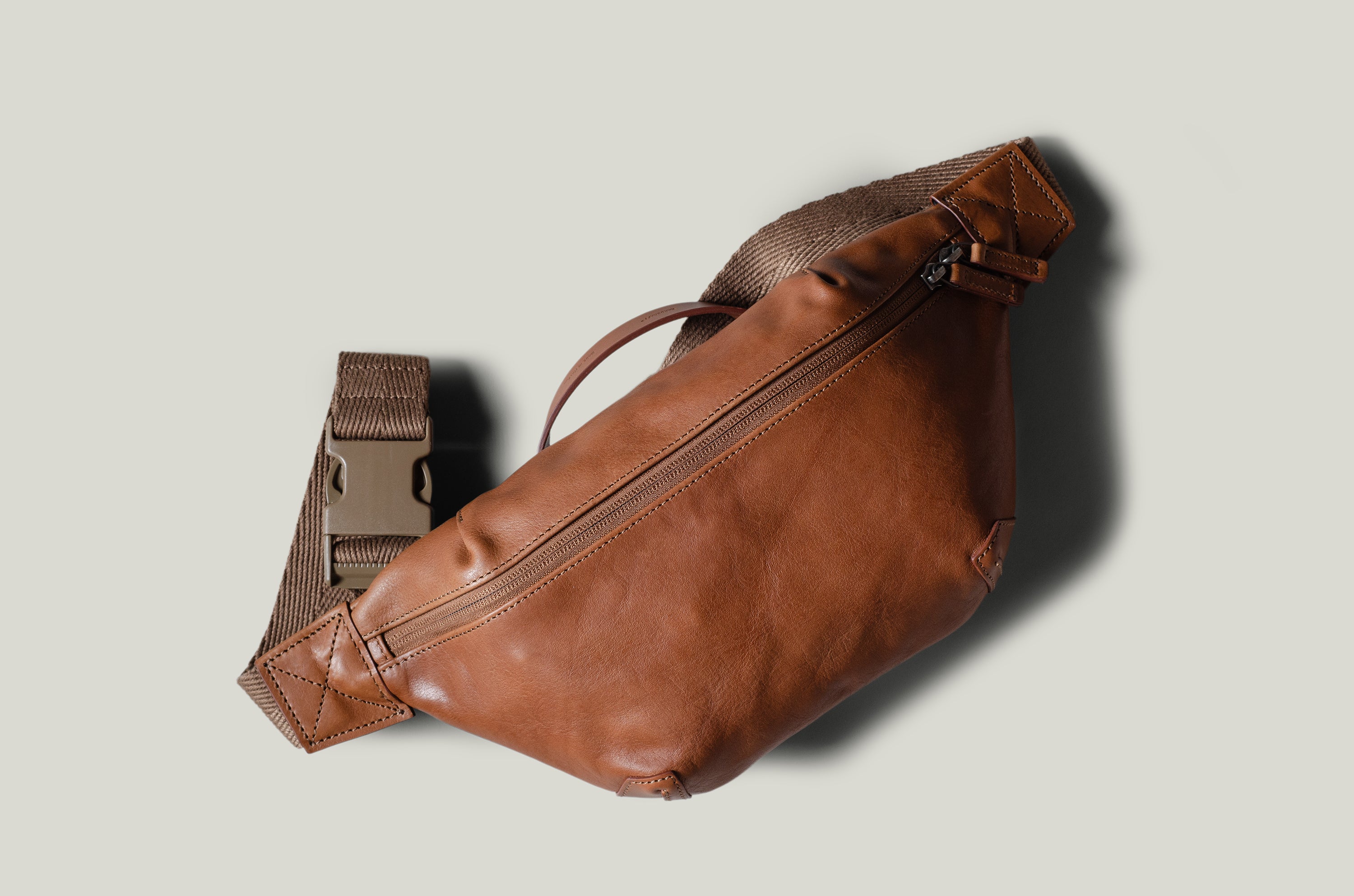 Brown leather waist cross body bag with brown leather details.