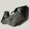 Green waist cross body bag with technical fabric and black leather details.