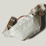 Beige waist cross body bag with technical fabric and brown leather details.
