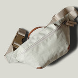 Beige waist cross body bag with technical fabric and brown leather details.