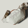 Beige waist cross body bag with technical fabric and brown leather details.
