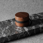 Brown leather watch case on a gray marble surface