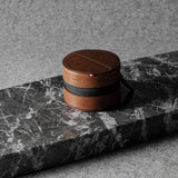 Brown leather watch case on a gray marble surface