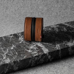 Brown leather watch case on a marble surface with a neutral background