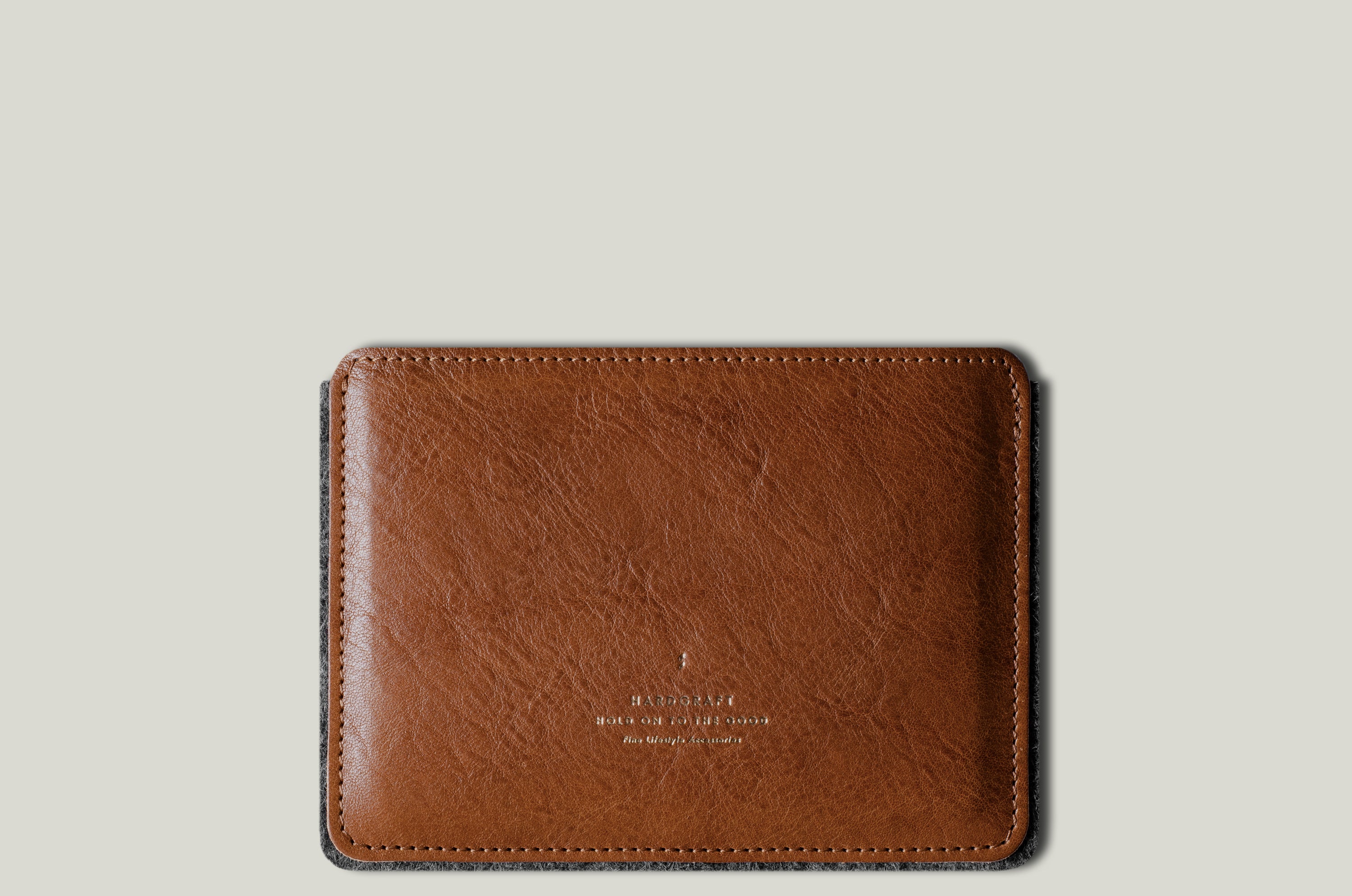 Brown leather passport wallet on a light gray background