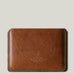 Brown leather passport wallet on a light gray background
