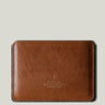 Brown leather passport wallet on a light gray background
