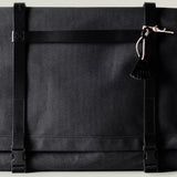 Black technical fabric messenger bag with black leather straps.