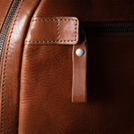 Close-up of a brown leather bag with zipper